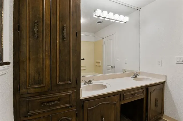 a bathroom with a sink vanity and a mirror