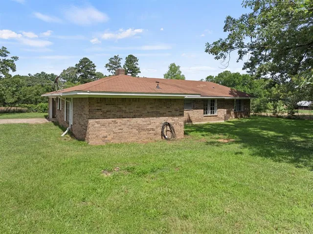 a front view of a house with a garden and plants