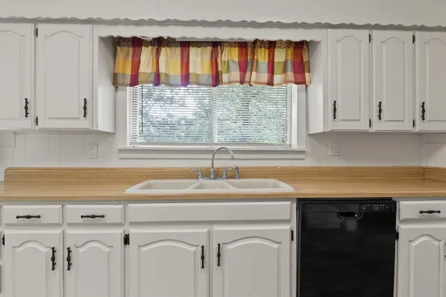 a view of a sink and a window in a kitchen