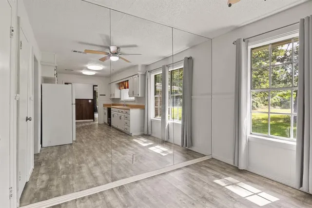 a view of a kitchen with a stove cabinets and a ceiling fan