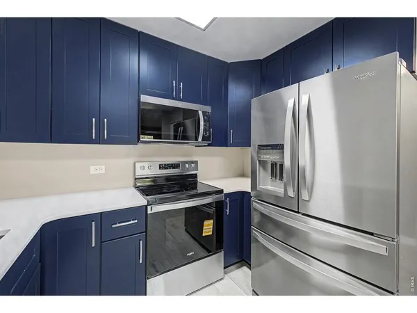 a kitchen with a refrigerator stove and microwave