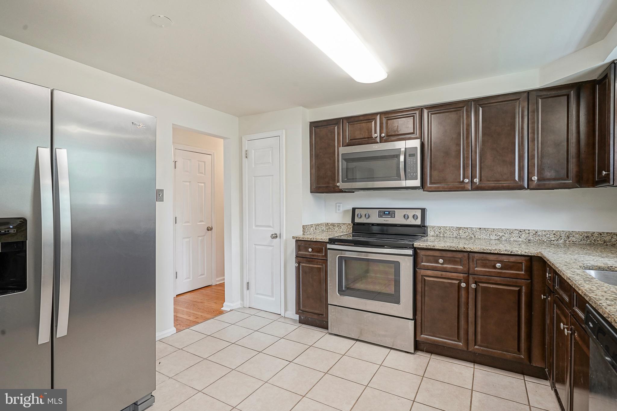 502 Pomona Road Cinnaminson, NJ 08077 - Photo 21 of 34 a kitchen with granite countertop a stove top oven and cabinets