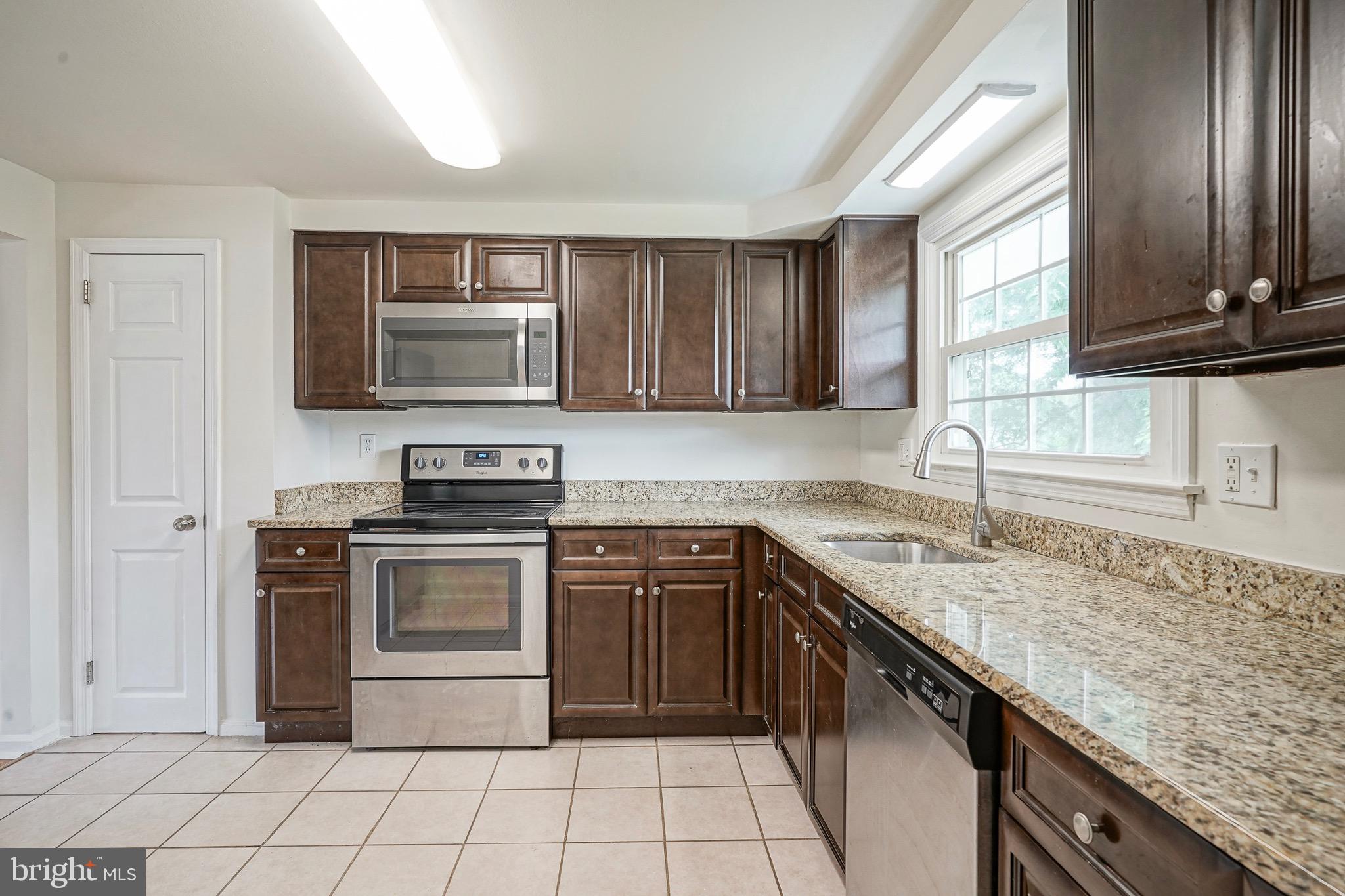 502 Pomona Road Cinnaminson, NJ 08077 - Photo 22 of 34 a kitchen with stainless steel appliances granite countertop a stove sink and microwave