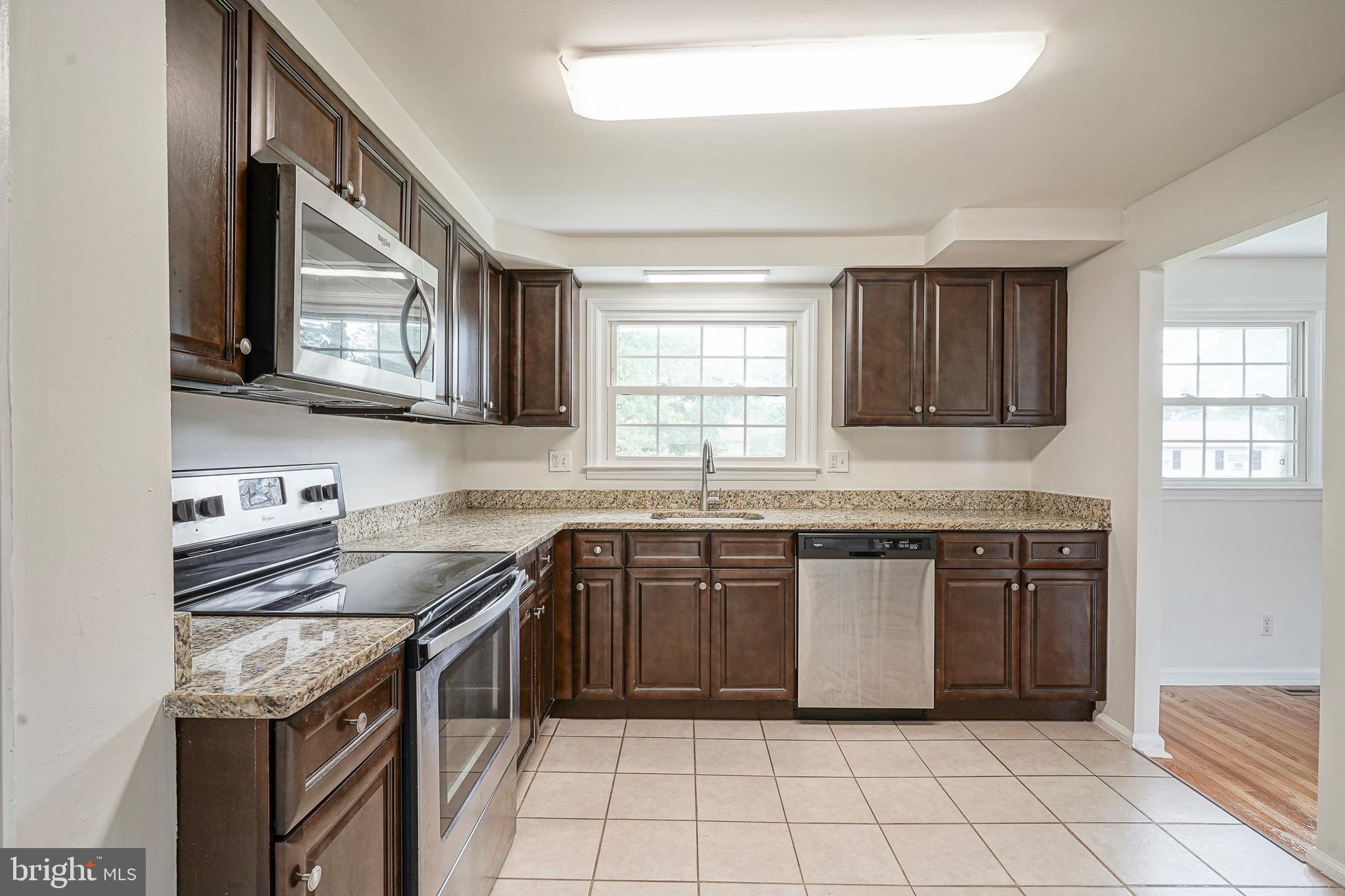 502 Pomona Road Cinnaminson, NJ 08077 - Photo 23 of 34 a kitchen with stainless steel appliances granite countertop a sink stove and cabinets