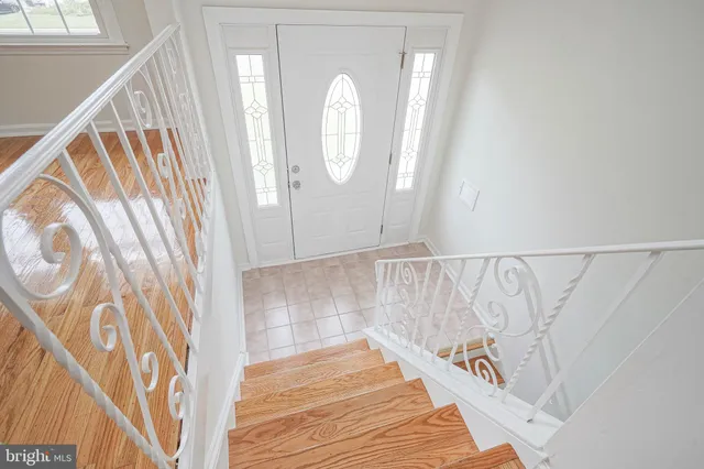 a view of a room with wooden floor and windows