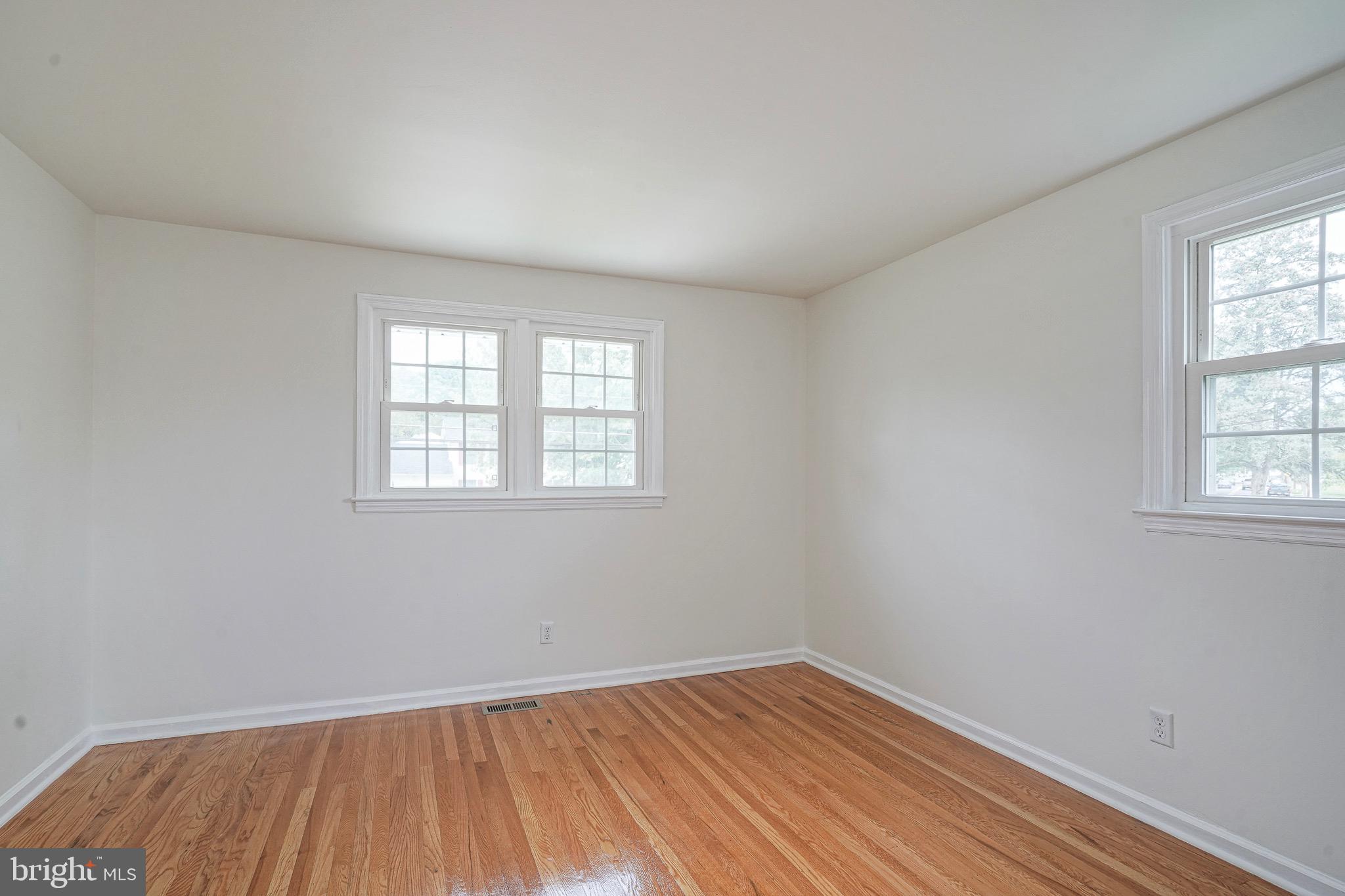 502 Pomona Road Cinnaminson, NJ 08077 - Photo 30 of 34 an empty room with wooden floor and windows