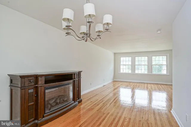 a kitchen with a window and wooden floor