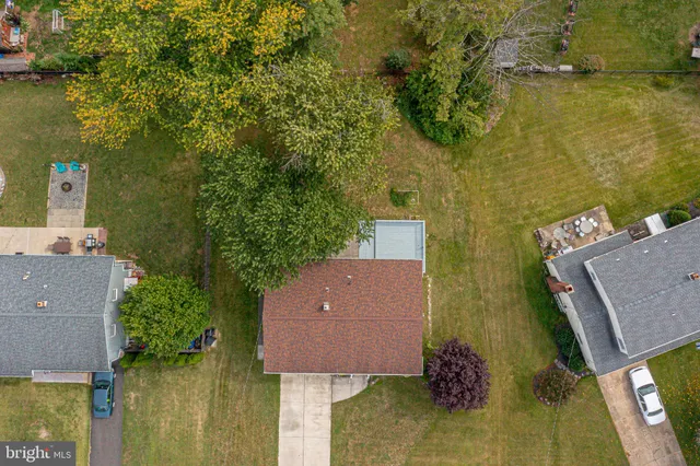 an aerial view of residential houses with outdoor space and swimming pool