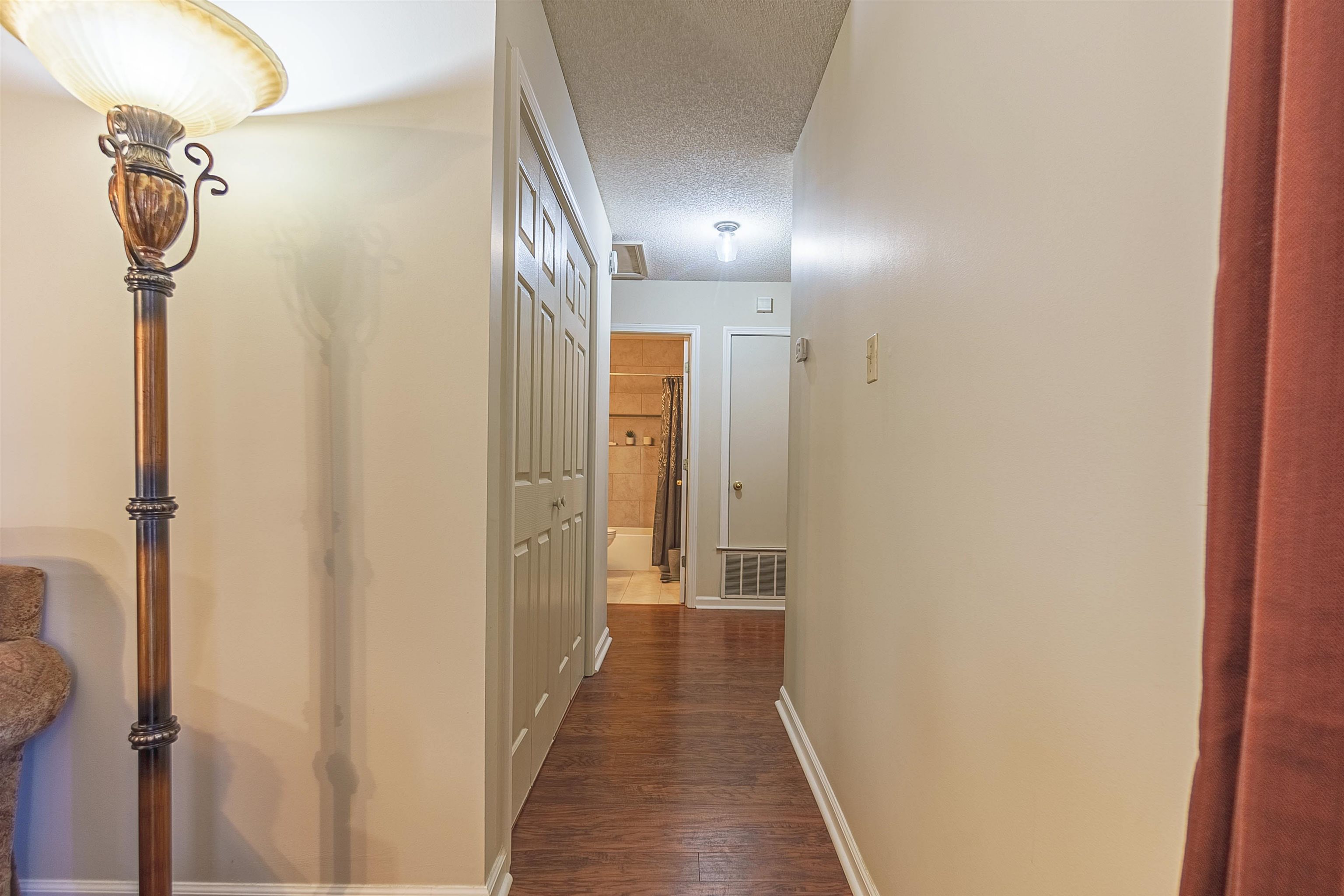 6419 Ragan Farm Drive Memphis, TN 38141 - Photo 14 of 27 Corridor with a textured ceiling and dark wood-type flooring