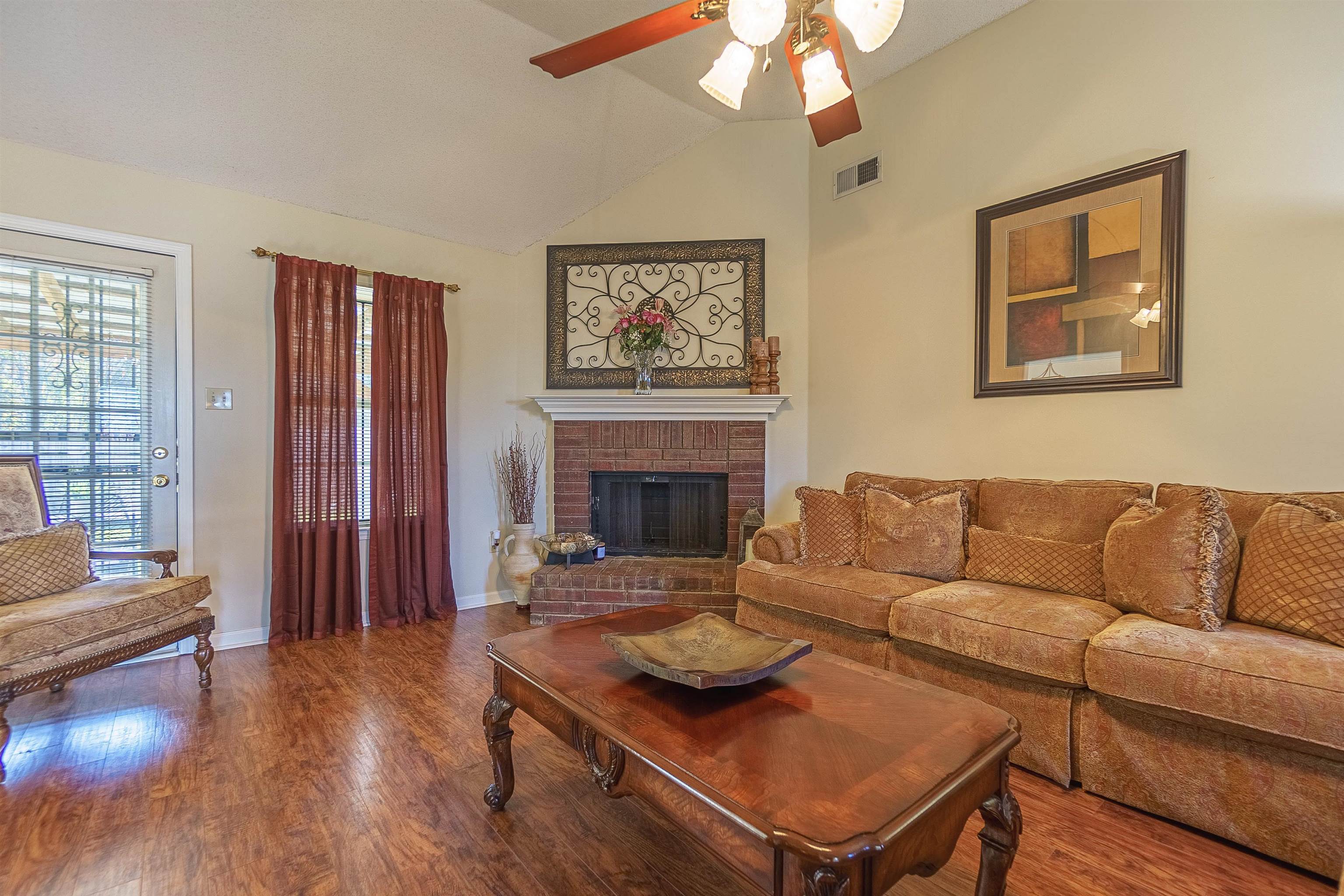 6419 Ragan Farm Drive Memphis, TN 38141 - Photo 4 of 27 Living room with a fireplace, wood-type flooring, ceiling fan, and lofted ceiling