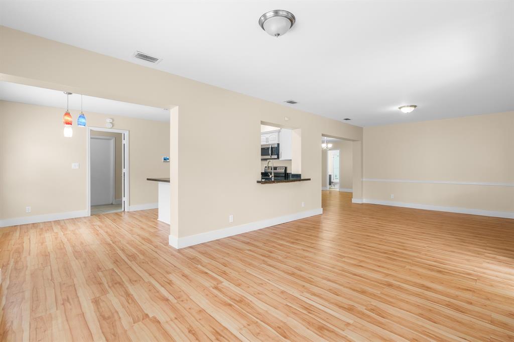 7836 Cloverfield Circle Boca Raton, FL 33433 - Photo 12 of 39 a view of empty room with wooden floor