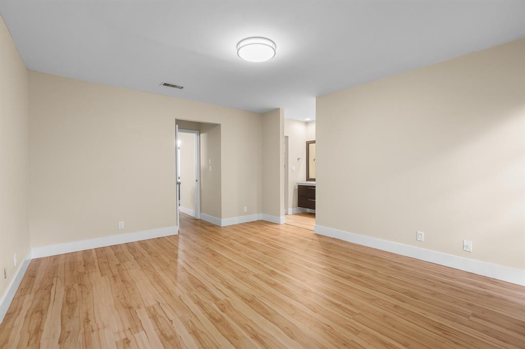 7836 Cloverfield Circle Boca Raton, FL 33433 - Photo 17 of 39 a view of an empty room with wooden floor and a window