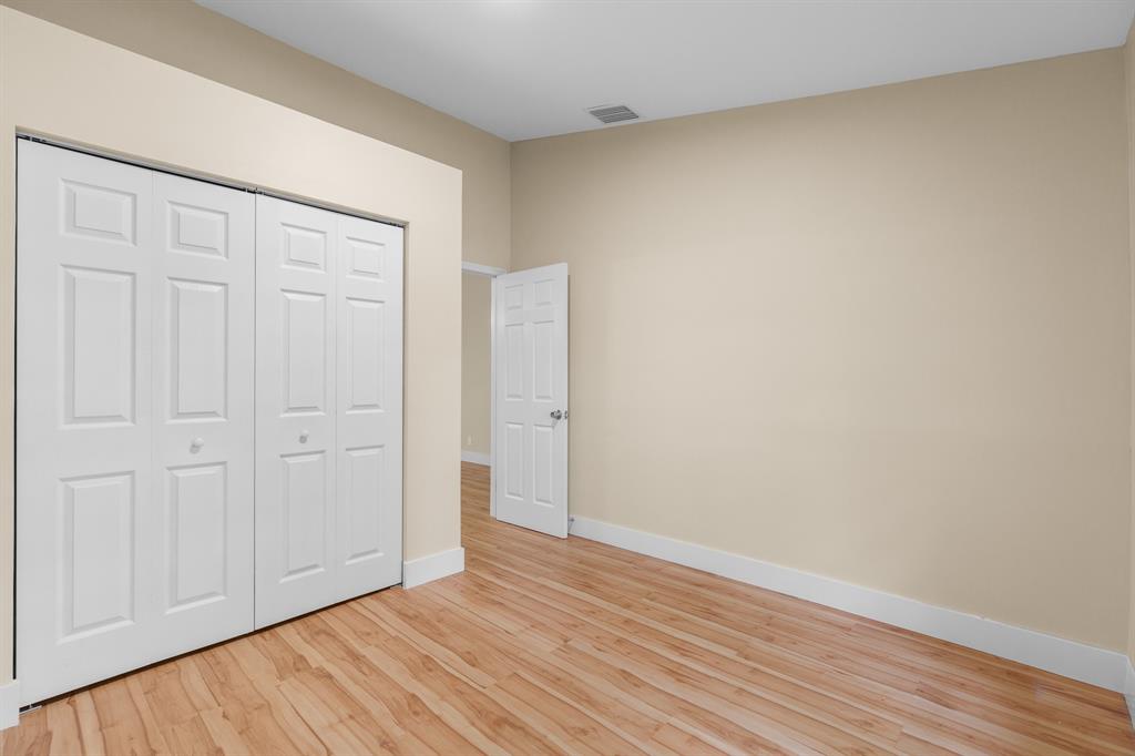 7836 Cloverfield Circle Boca Raton, FL 33433 - Photo 22 of 39 a view of an empty room with wooden floor