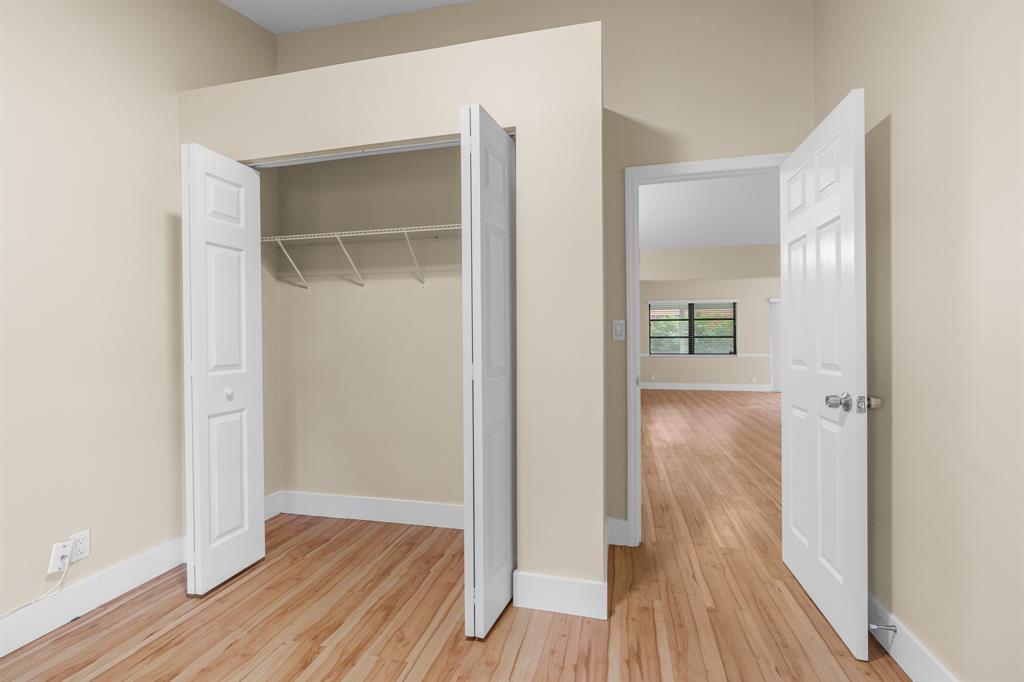 7836 Cloverfield Circle Boca Raton, FL 33433 - Photo 23 of 39 a view of a hallway with wooden floor