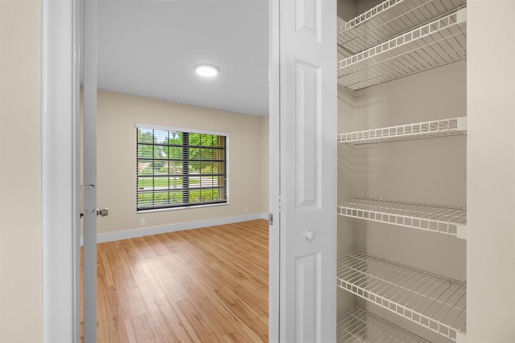 7836 Cloverfield Circle Boca Raton, FL 33433 - Photo 24 of 39 a view of a room with wooden floor and windows