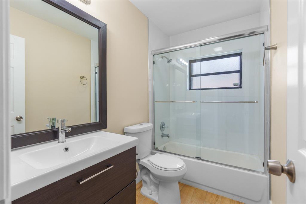 7836 Cloverfield Circle Boca Raton, FL 33433 - Photo 25 of 39 a bathroom with a sink a toilet and shower