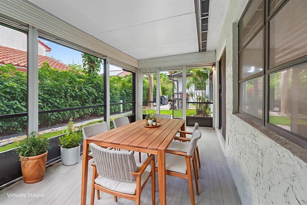 7836 Cloverfield Circle Boca Raton, FL 33433 - Photo 32 of 39 a view of a patio with a dining table and chairs
