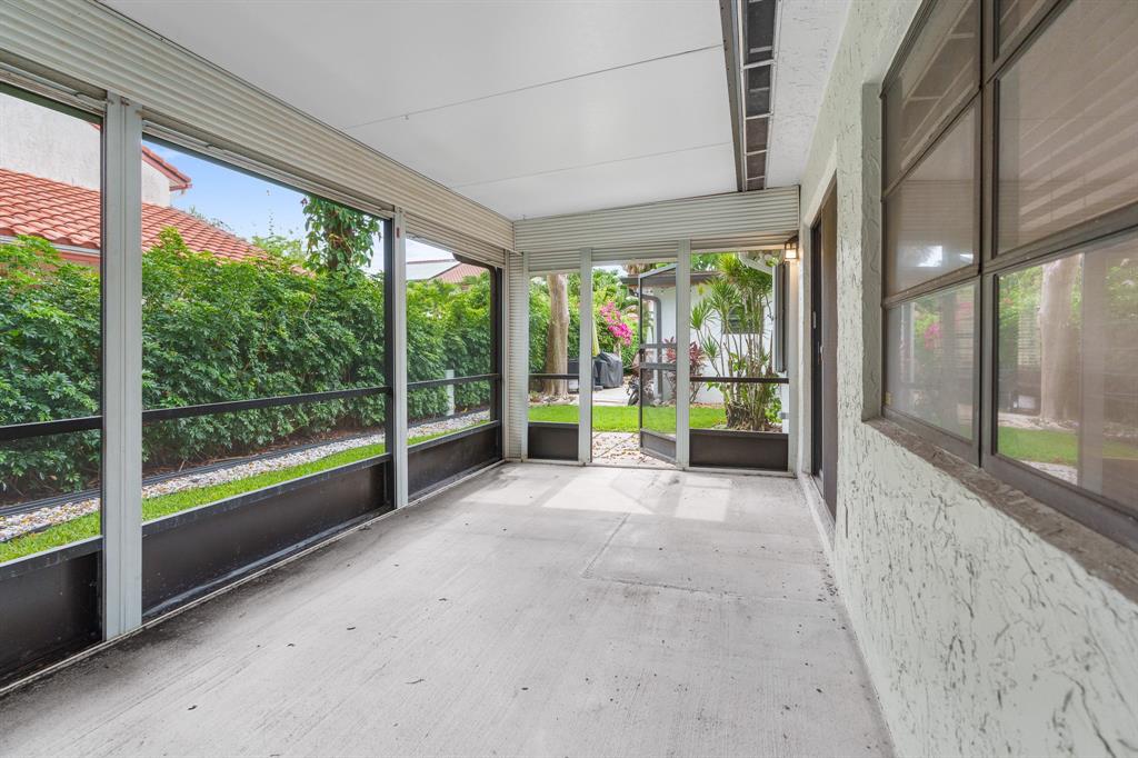 7836 Cloverfield Circle Boca Raton, FL 33433 - Photo 33 of 39 a view of an empty room with wooden floor and a balcony