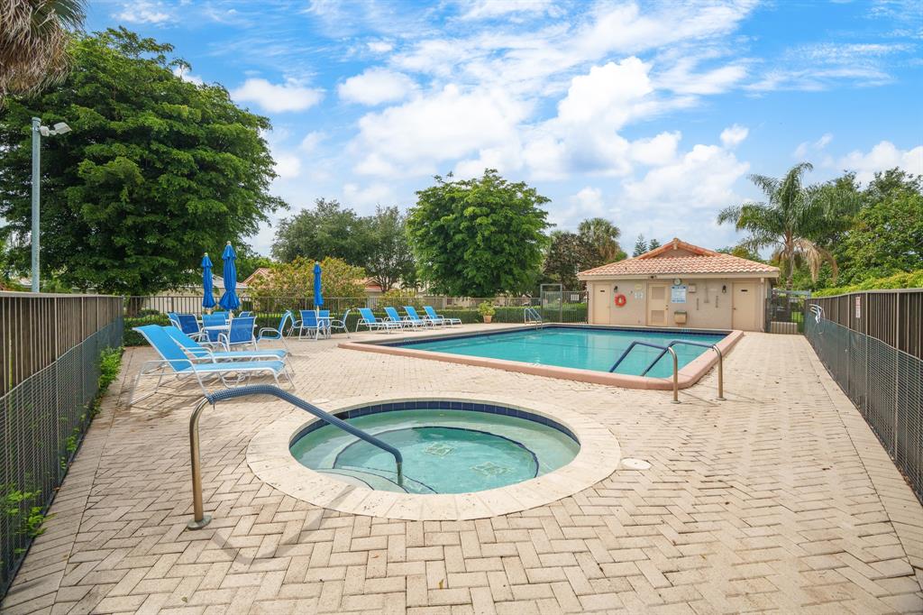 7836 Cloverfield Circle Boca Raton, FL 33433 - Photo 39 of 39 a view of a swimming pool with a lounge chair
