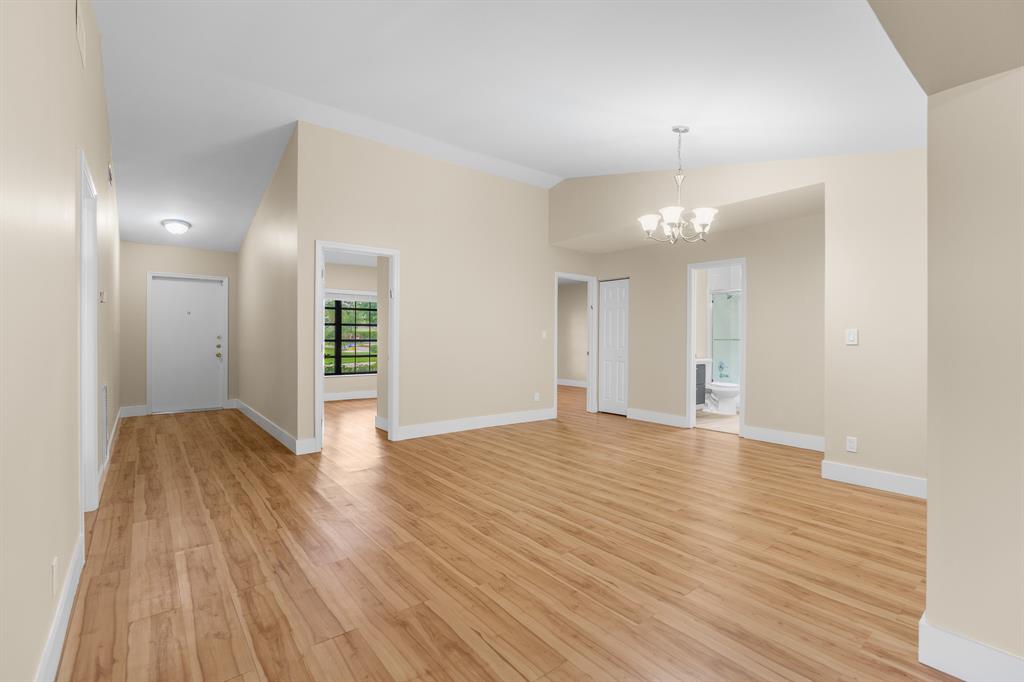 7836 Cloverfield Circle Boca Raton, FL 33433 - Photo 4 of 39 a view of empty room with wooden floor