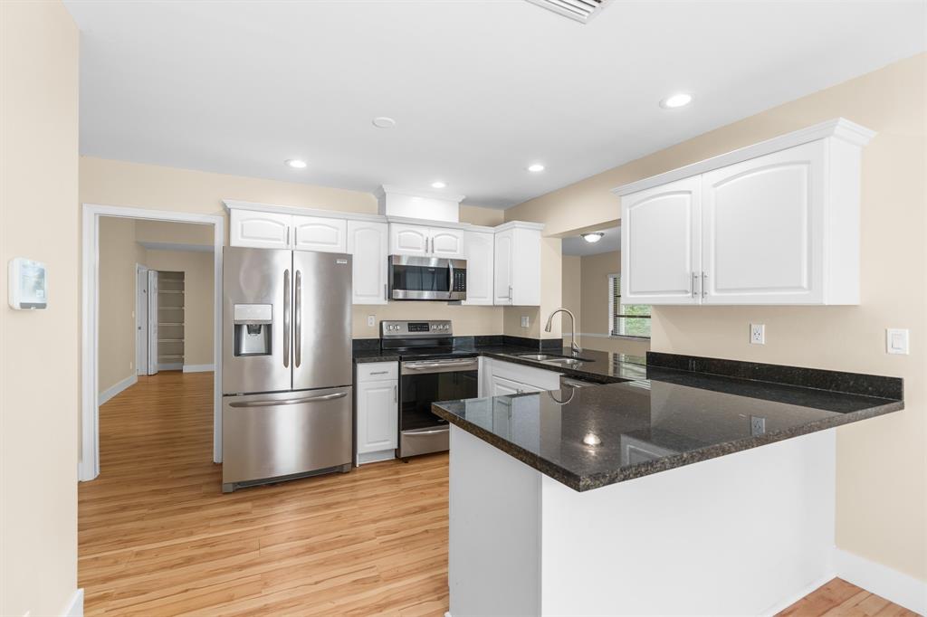 7836 Cloverfield Circle Boca Raton, FL 33433 - Photo 7 of 39 a kitchen with granite countertop a refrigerator and a sink