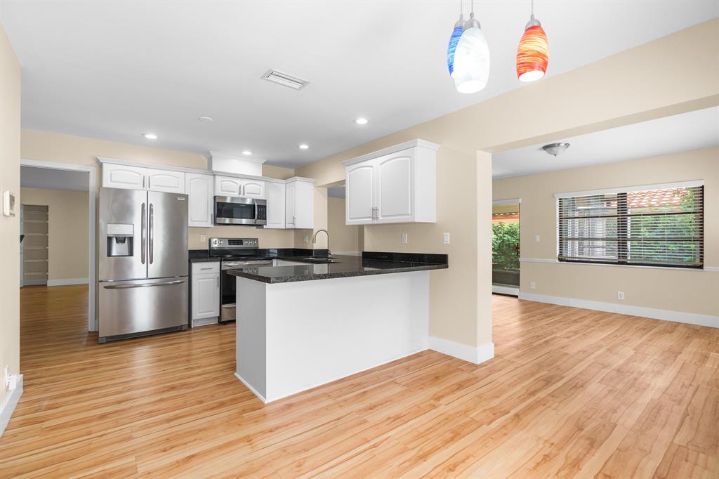 7836 Cloverfield Circle Boca Raton, FL 33433 - Photo 8 of 39 a kitchen with stainless steel appliances granite countertop a refrigerator and a stove top oven