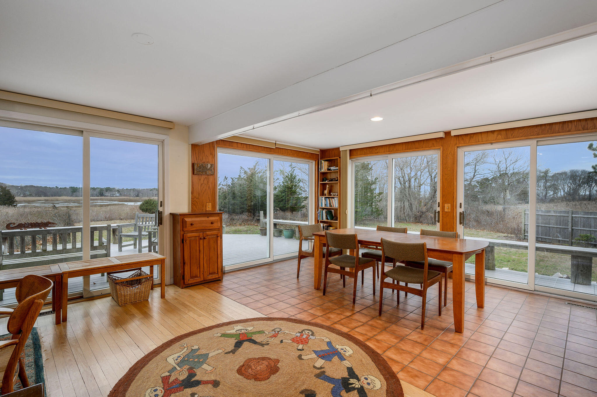 52 Captain Linnell Road Orleans, MA 02653 - Photo 12 of 45 a dining room with furniture water view and a floor to ceiling window