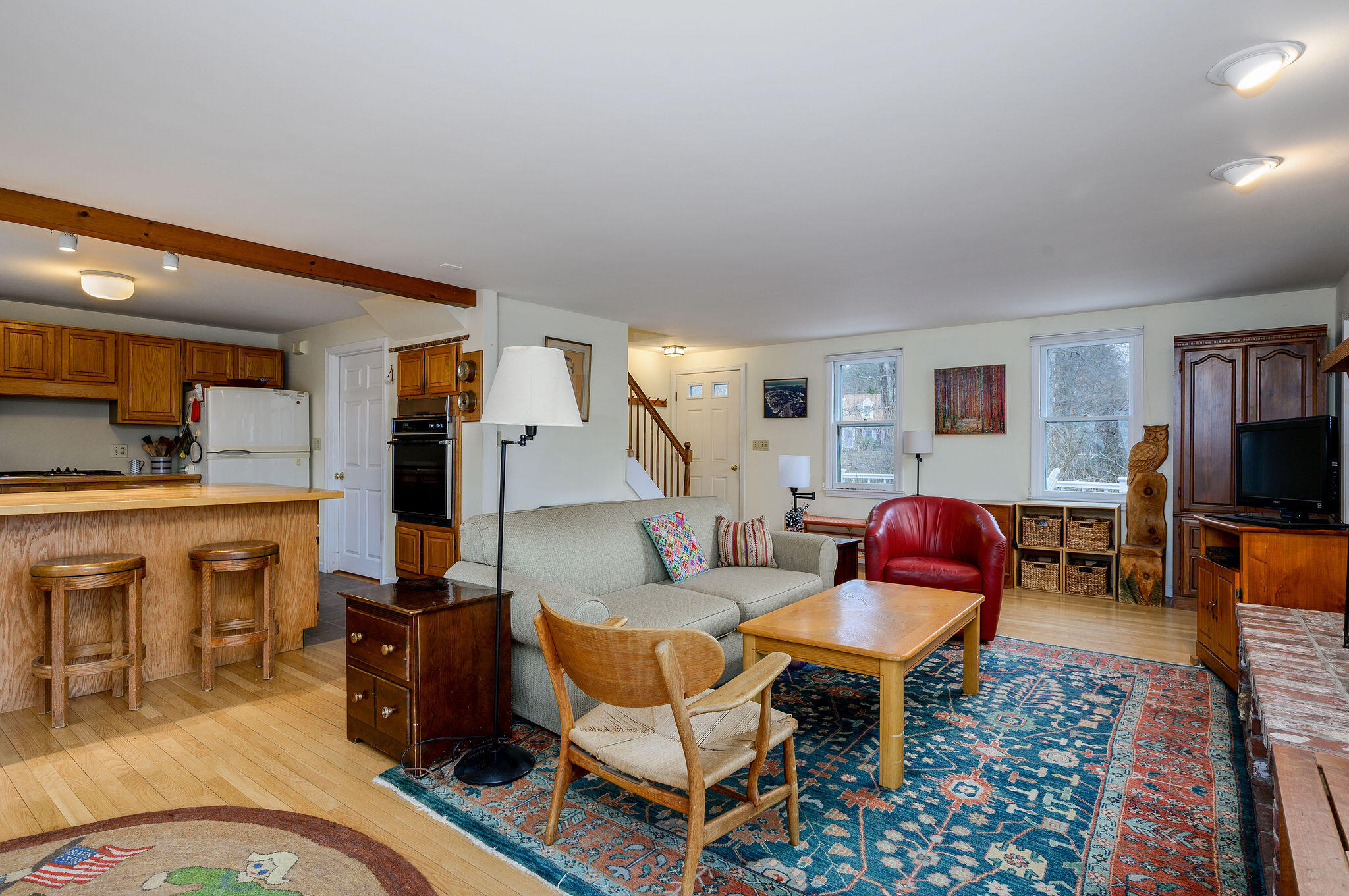 52 Captain Linnell Road Orleans, MA 02653 - Photo 15 of 45 a living room with furniture a flat screen tv and kitchen view