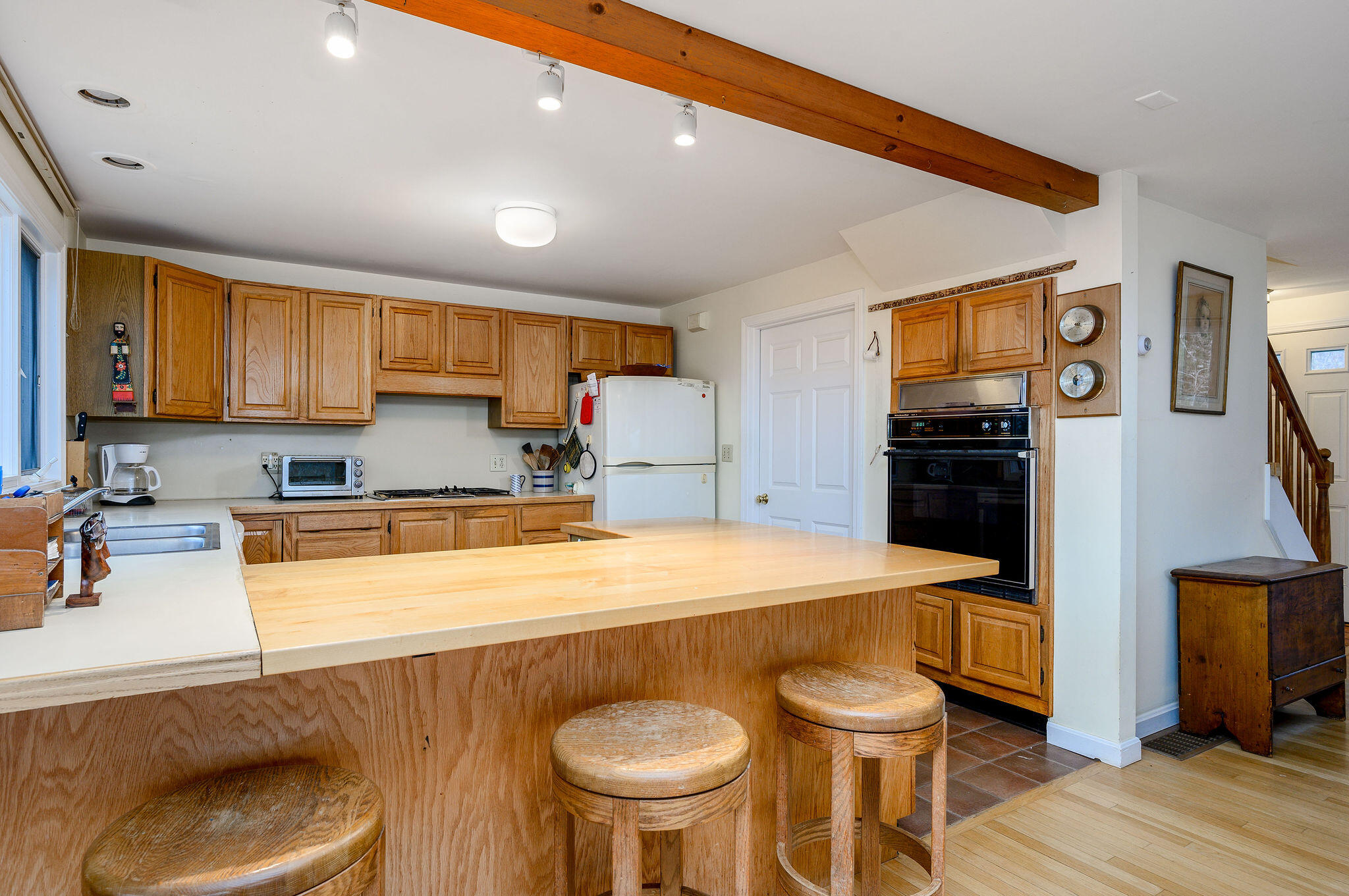 52 Captain Linnell Road Orleans, MA 02653 - Photo 18 of 45 a kitchen with stainless steel appliances granite countertop a sink a stove a refrigerator cabinets and chairs