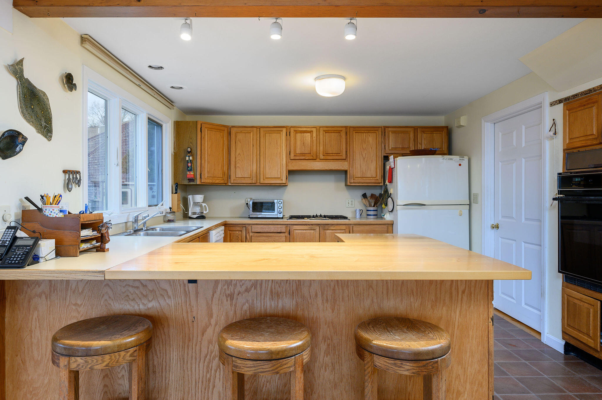52 Captain Linnell Road Orleans, MA 02653 - Photo 20 of 45 a kitchen with a table chairs sink and cabinets