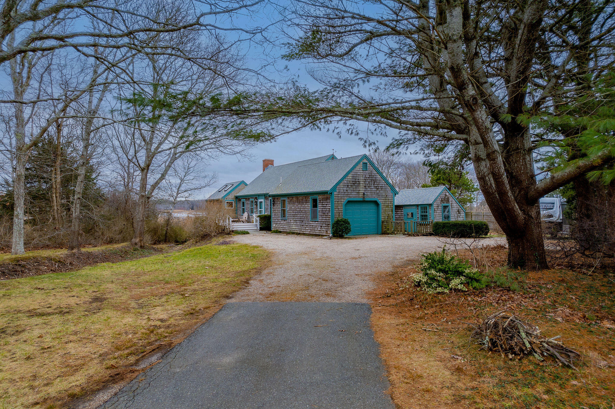 52 Captain Linnell Road Orleans, MA 02653 - Photo 6 of 45 a front view of a house with a yard and garage