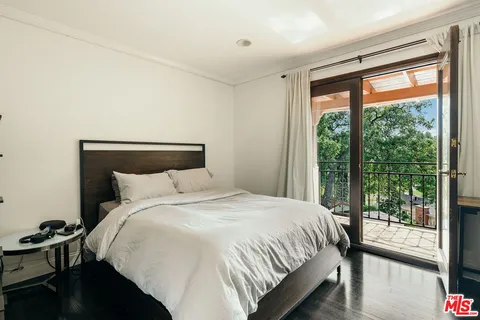 a spacious bedroom with a bed and a fireplace