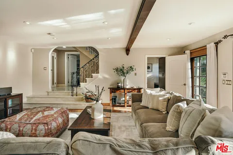 a spacious bathroom with a double vanity sink a large mirror and shower