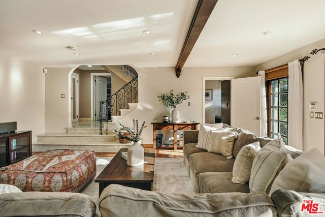 a spacious bathroom with a double vanity sink a large mirror and shower