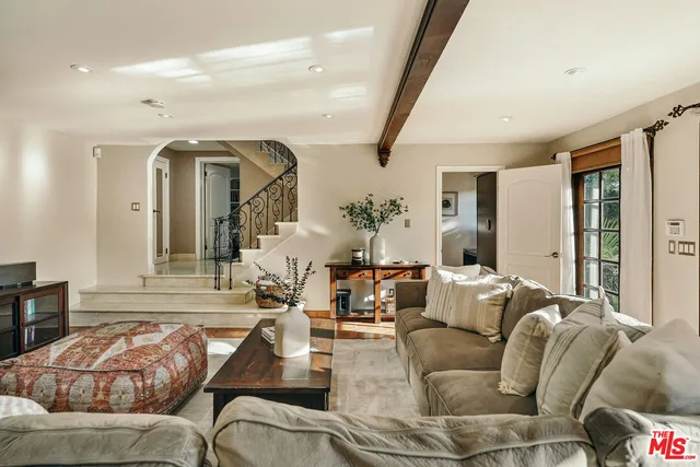 a spacious bathroom with a double vanity sink a large mirror and shower