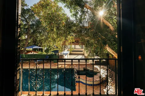 a view of balcony with two flat screen tv and outdoor seating