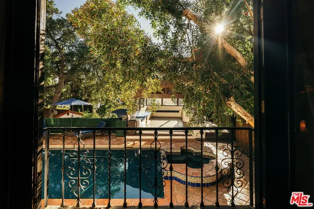 a view of balcony with two flat screen tv and outdoor seating