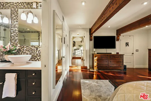 a patio with a table and chairs and potted plants