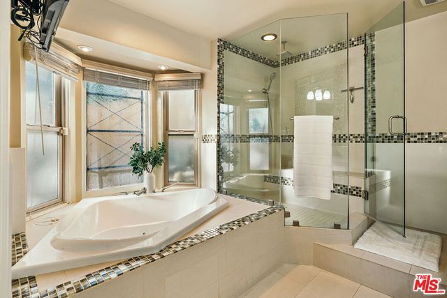 a view of a patio with table and chairs with wooden floor and fence