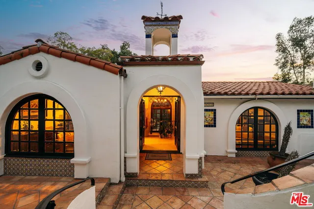 a living room with fireplace furniture and a large window