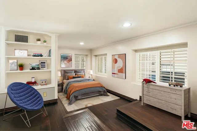 a front view of a house with a tree