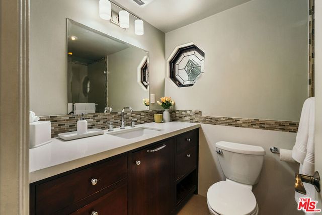 a view of white house with a large tree