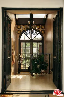 a living room with fireplace furniture and a large window