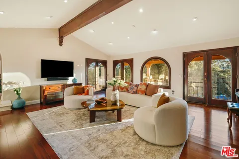 a kitchen with stainless steel appliances granite countertop a sink a stove and a wooden cabinets