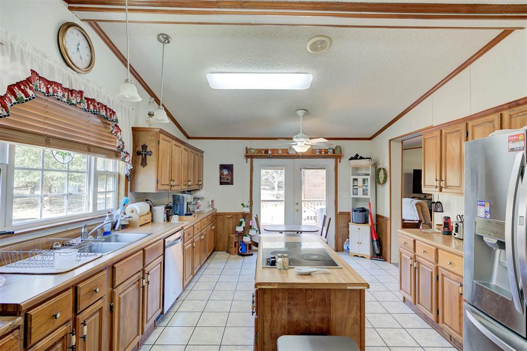 4896 Quiet Acres Road Shreveport, LA 71107 - Photo 13 of 39 a kitchen with stainless steel appliances a stove a sink and a refrigerator