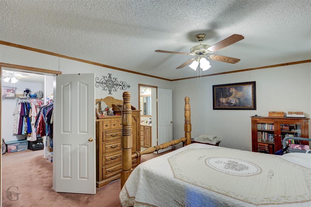 4896 Quiet Acres Road Shreveport, LA 71107 - Photo 13 of 39 a bedroom with a bed and a chandelier