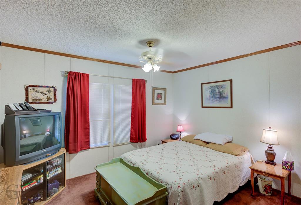 4896 Quiet Acres Road Shreveport, LA 71107 - Photo 18 of 39 a bedroom with a bed and a flat screen tv