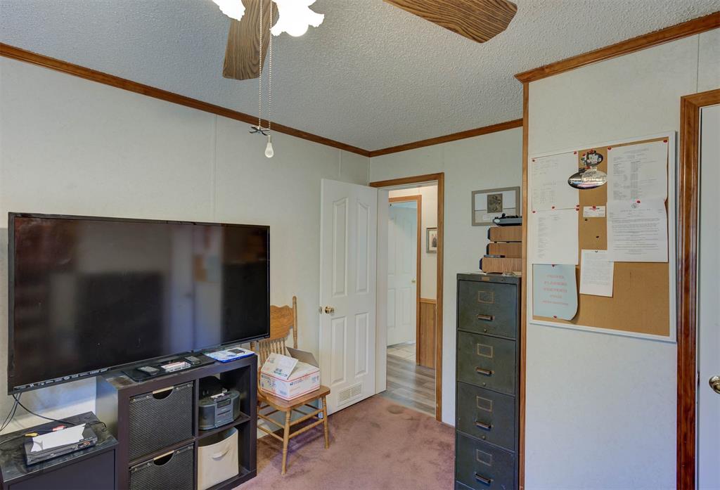4896 Quiet Acres Road Shreveport, LA 71107 - Photo 20 of 39 a room with furniture and flat screen tv