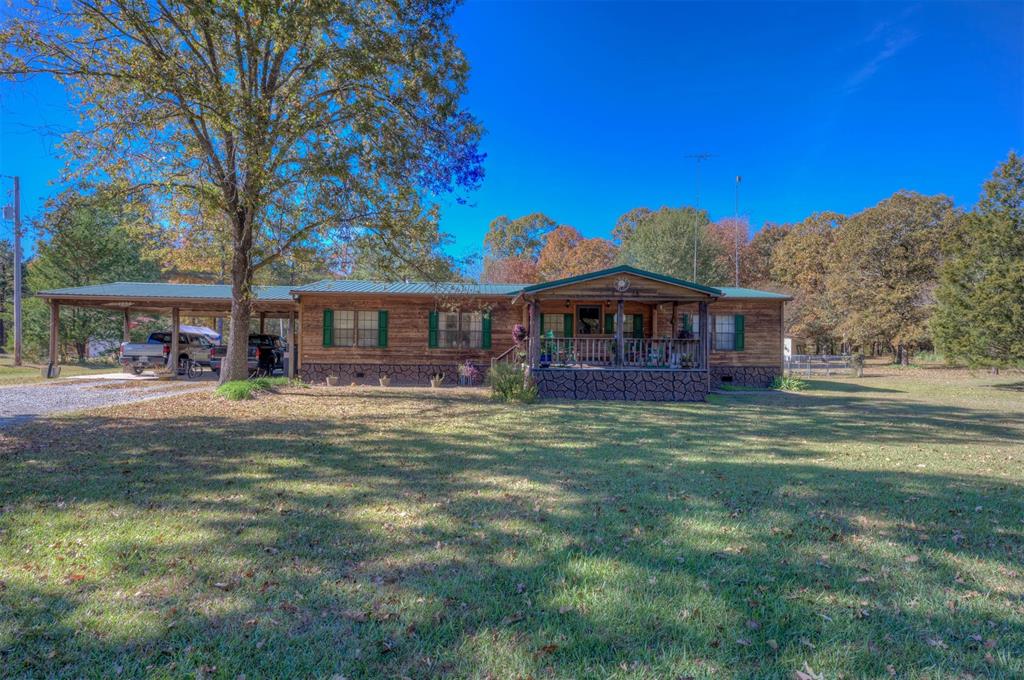 4896 Quiet Acres Road Shreveport, LA 71107 - Photo 7 of 39 a front view of a house with garden