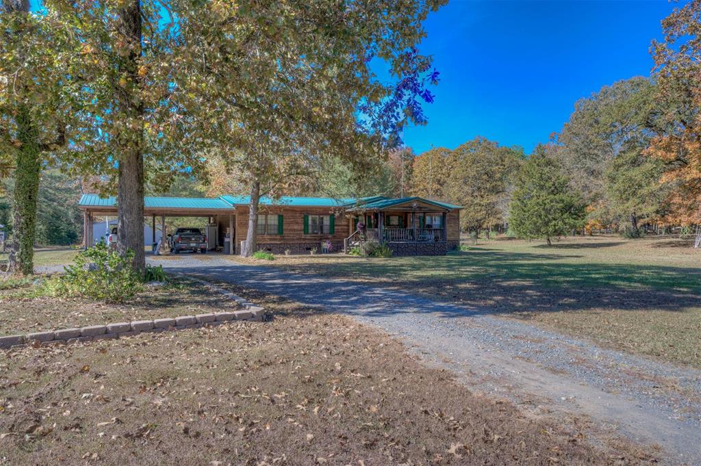 4896 Quiet Acres Road Shreveport, LA 71107 - Photo 8 of 39 a front view of a house with a garden